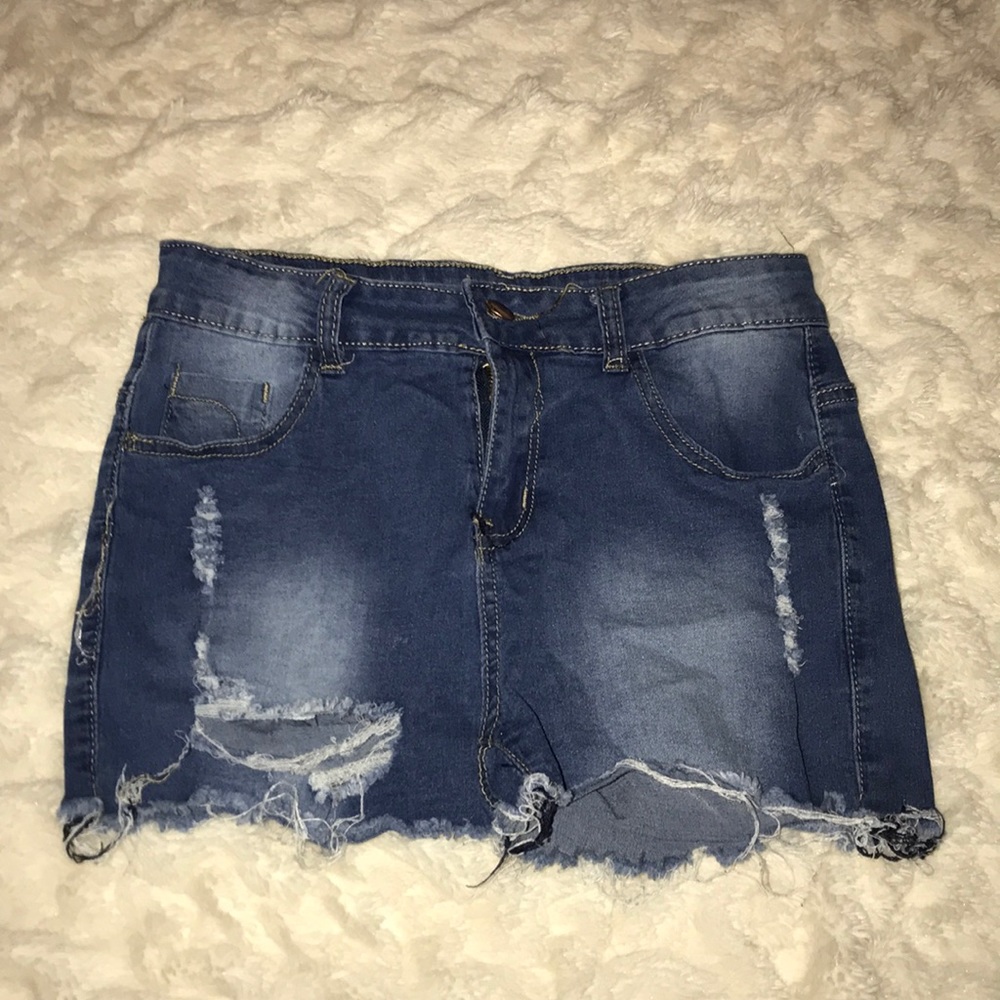 Jean shorts with holes.